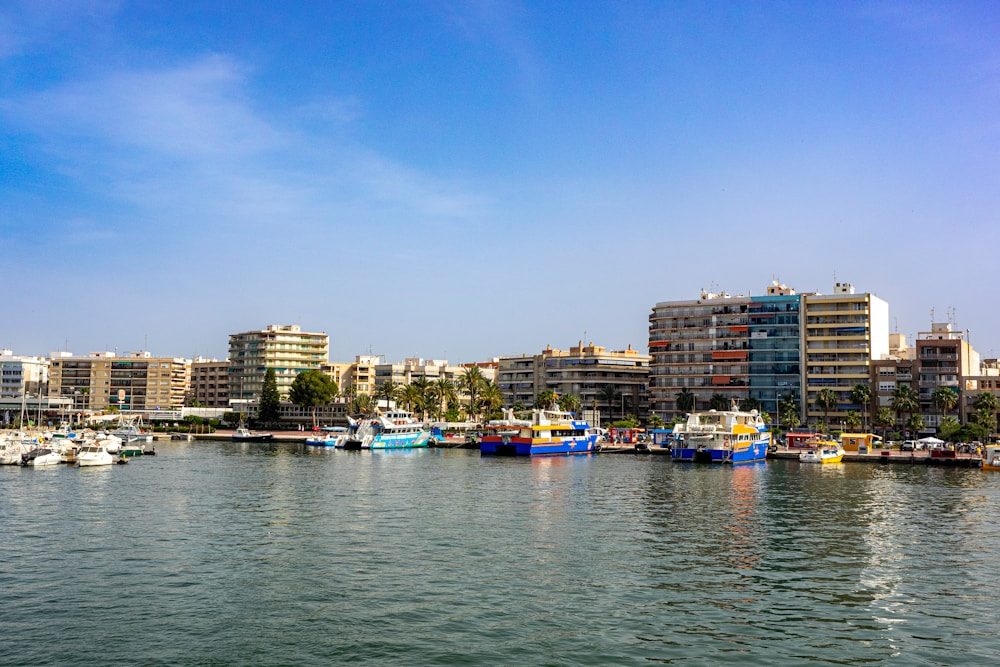 a body of water with boats in it and buildings around it
